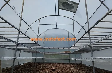 Hybrid solar dryer with solar collector panels, drying chamber trays, ventilation fan, and auxiliary heating system used for drying agricultural products like fruits, vegetables, and grains efficiently using solar and backup energy.
