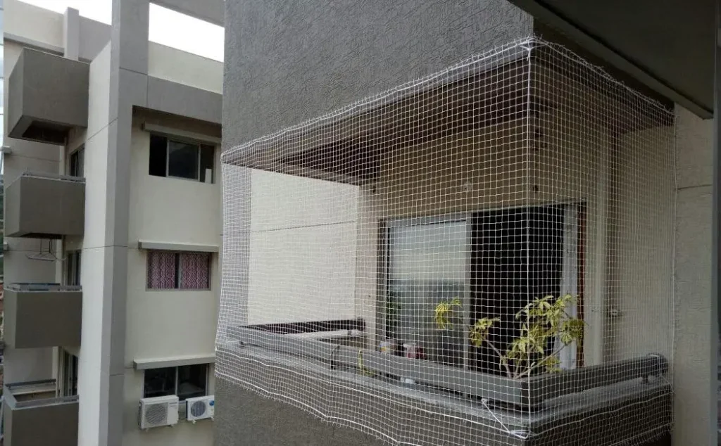 Bird netting installed over a greenhouse and agricultural farm to protect crops from birds.